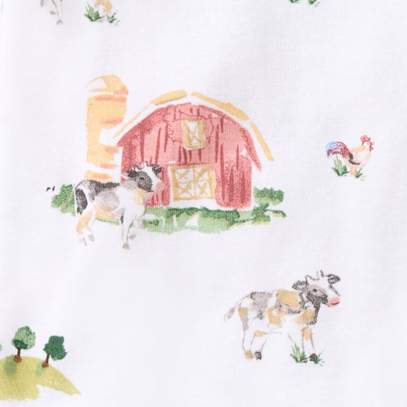 White fabric with a watercolor-style farm print featuring a red barn, yellow silo, green grass, and cows and a rooster.