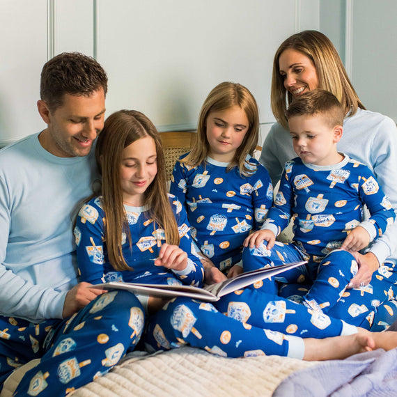Men's organic cotton pajama set in blue with dreidel icon pattern, long-sleeve top and pants