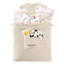 Neutral baby gift set in beige tote with patterned onesies, striped blanket, panda plush