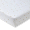 Light beige fitted crib sheet corner with allover small honeybee print