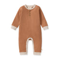 Camel knit henley jumpsuit with front button placket and contrast cuffs