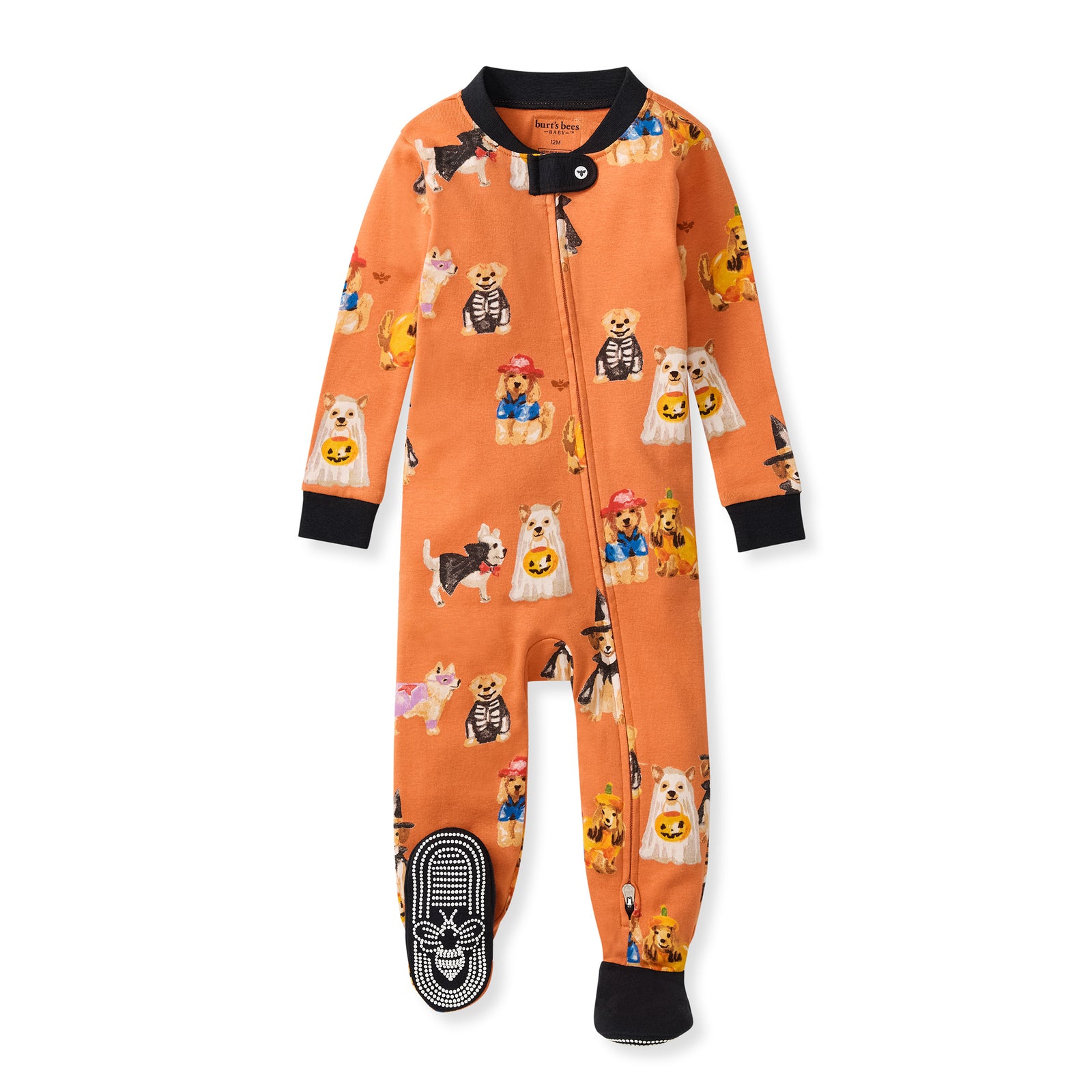 Orange zip-front footed sleeper with black cuffs, dog-and-pumpkin character print