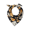 Black triangular pet bandana with orange and white cartoon dog faces pattern