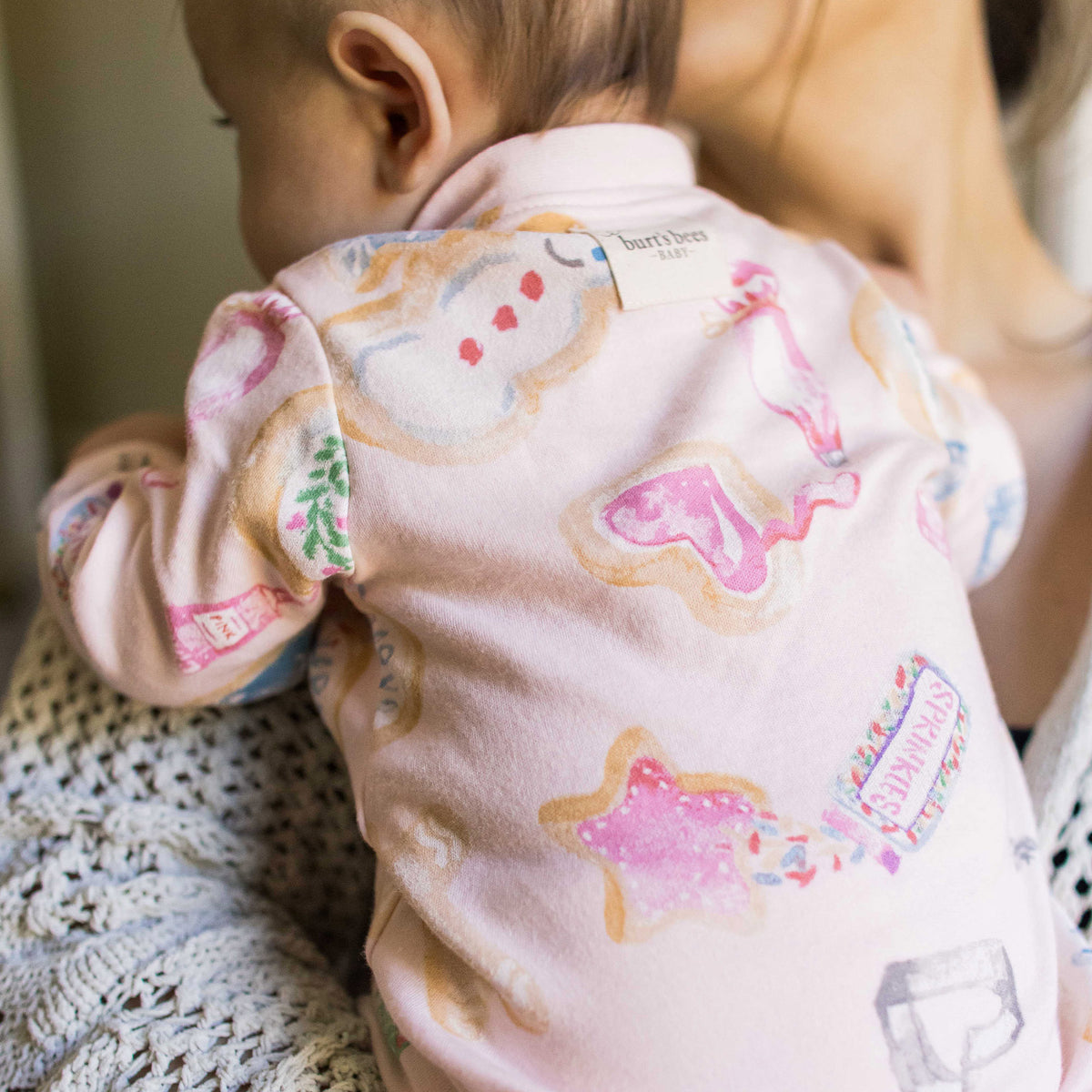 Light pink footed organic cotton sleeper with colorful animal prints, long sleeves - View 2