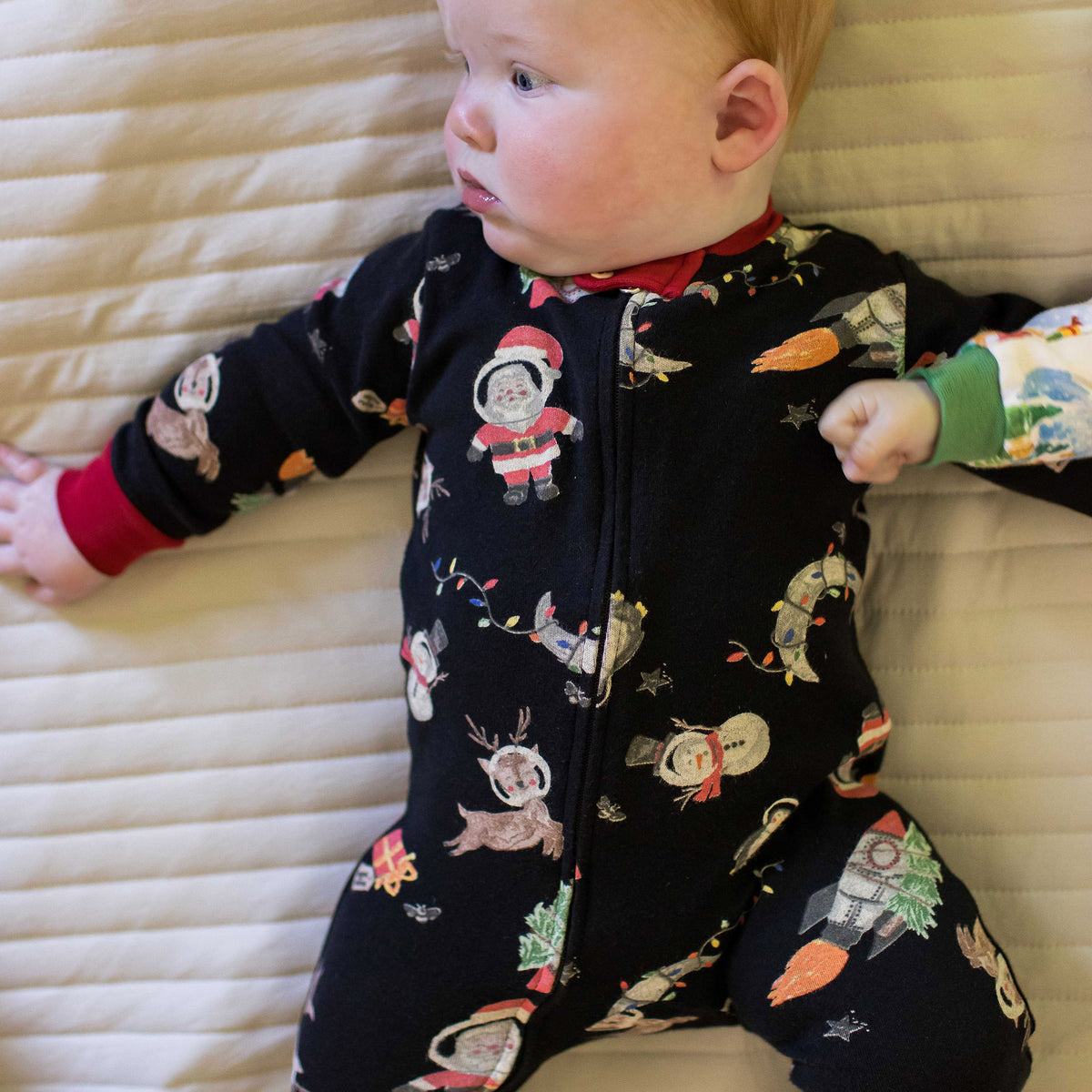 Kids two-piece pajama set, dark navy with astronaut and animal print, red cuffs. - View 2