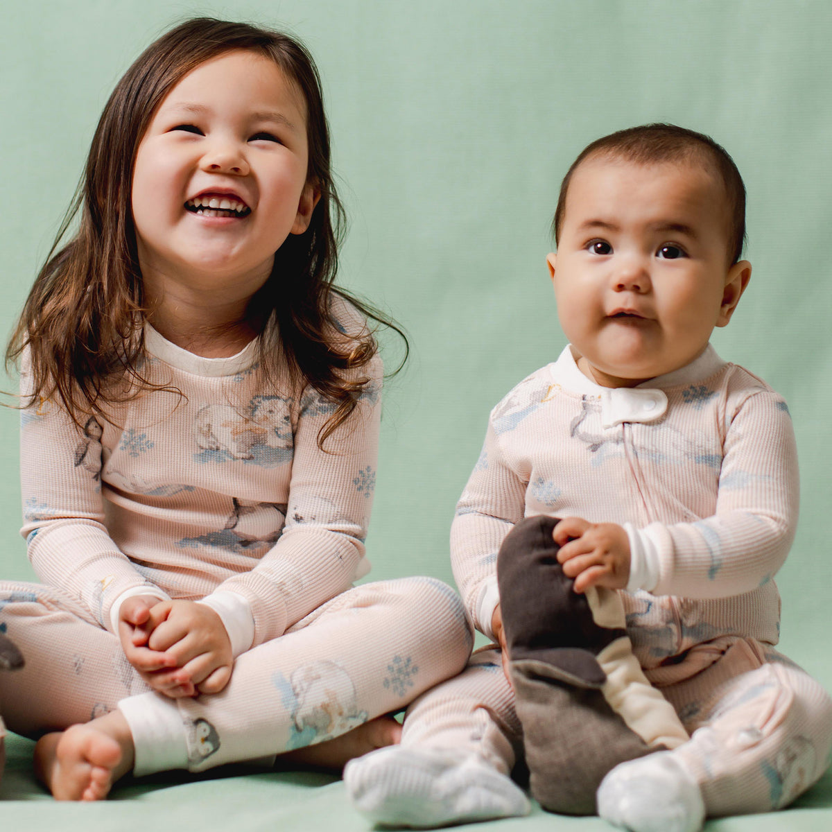 Footed baby sleeper pajama in light pink with blue animal print, long sleeves - View 2