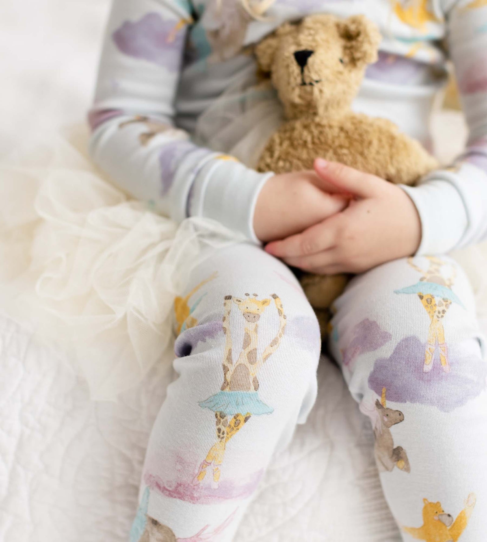 Close up of Toddler girl wearing giraffe watercolor ballet print pajamas