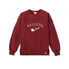 Women's maroon crewneck sweatshirt with 'BELIEVE' graphic and Santa sleigh