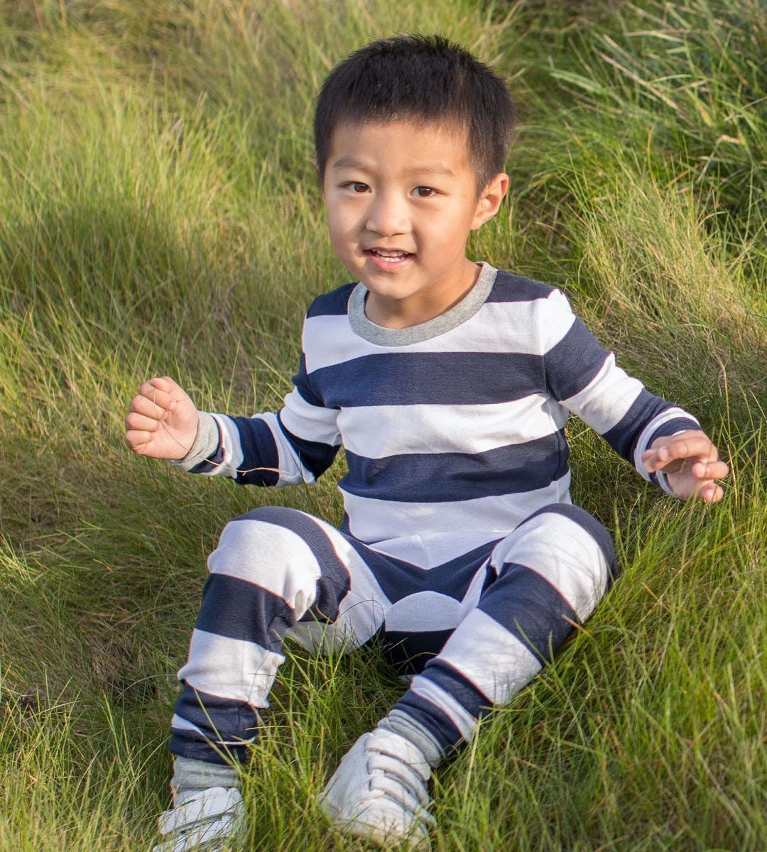 Rugby Stripe Snug Fit Organic Baby two piece Pajamas
navy blue boy in grass